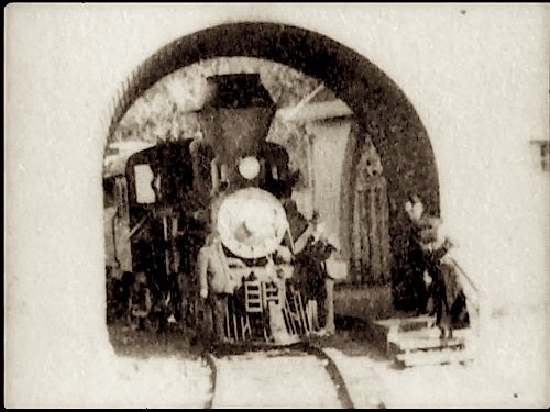 A steam locomotive under the arched bridge at the Tavern of Tamalpais