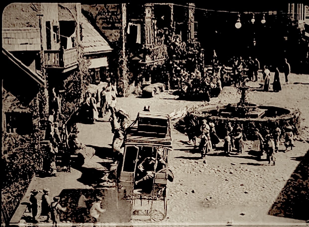 Film still: a stagecoach arrives in the busy square of the alpine village