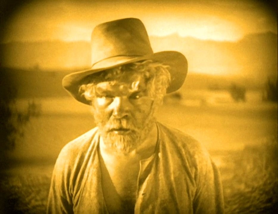 Film still: Gibson Gowland as McTeague, sun-scorched and bearded, in Death Valley