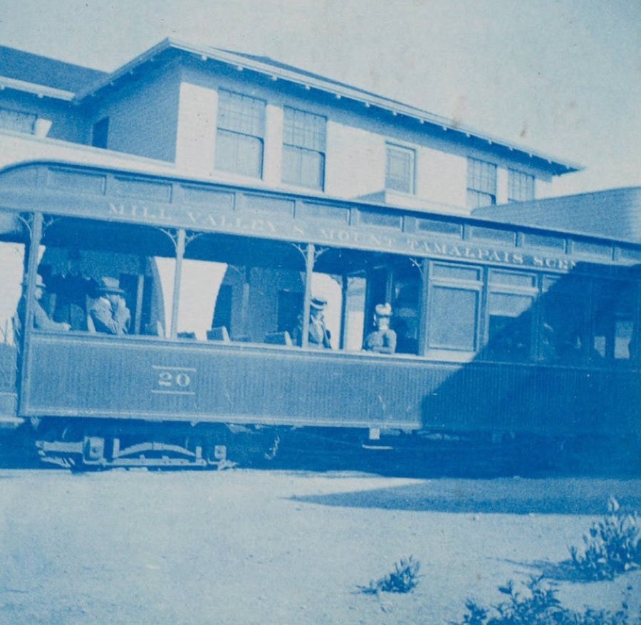 Cyanotype: open passenger car No. 20, lettered Mill Valley and Mount Tamalpais Scenic Railway, with passengers, in front of the Tavern